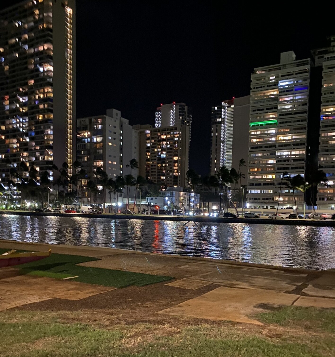 Waikīkī buildings reflected at night in the Ala Wai Canal