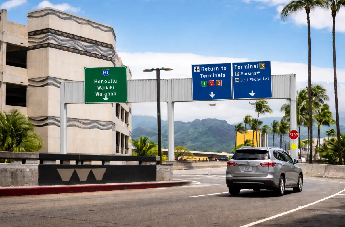Road signs at Daniel K. Inouye International Airport directing travelers toward Waikiki